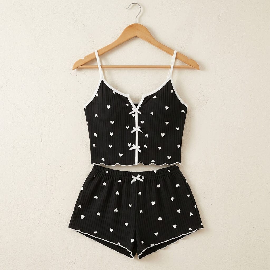 The Viola Ribbed Cami Set in Mini Hearts in Black, on a wooden hanger